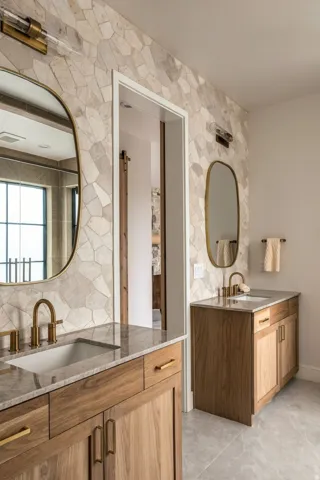 Dual vanity with wood-finish cabinetry, integrated sinks, and polished countertops