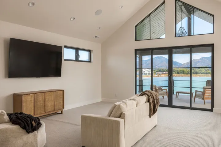 Vaulted ceilings, recessed lighting, and large sliding glass doors