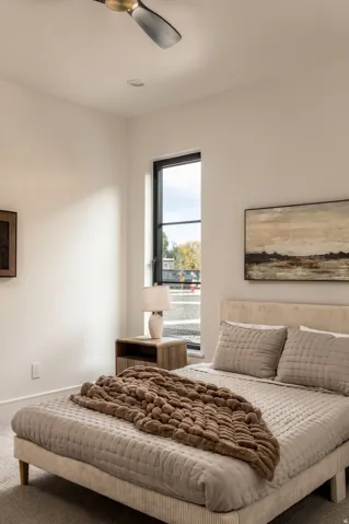 Recessed ceiling lighting, ceiling fan, contemporary window with dark trim, light wall color, carpeted flooring
