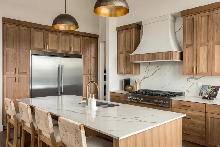Expansive kitchen island with a waterfall edge and integrated sink