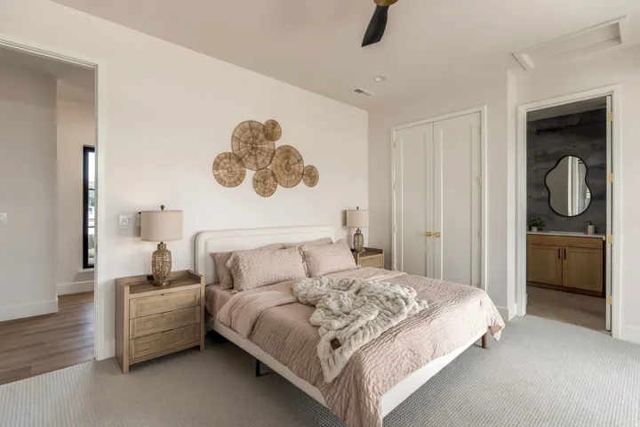 Carpeted flooring, bi-fold closet doors, and an attached ensuite with a wood-finish vanity