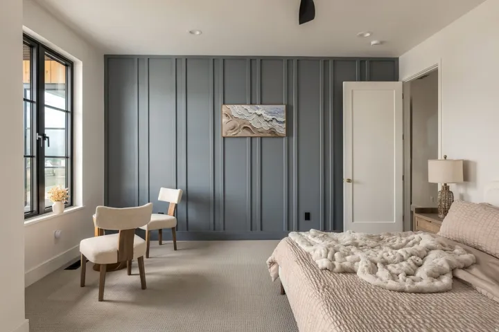 Accent wall with vertical paneling, recessed lighting, black-framed window, and neutral carpeting