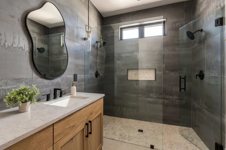 Wood-finish vanity with a rectangular undermount sink, light-toned countertop, and matte black fixtures
