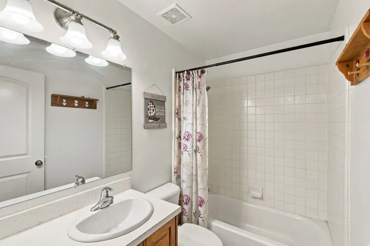 White subway tile shower surround with a built-in tub