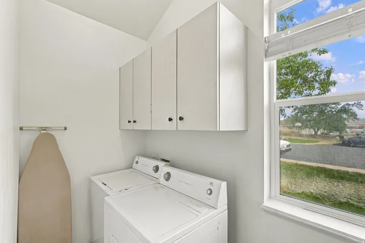 Dedicated laundry area with upper cabinetry