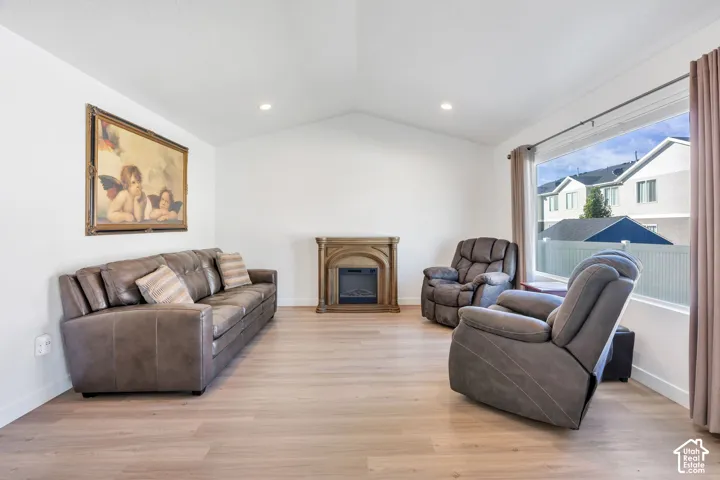 Vaulted ceilings, recessed lighting, wood-finish flooring, large window. Electrical fireplace is excluded.