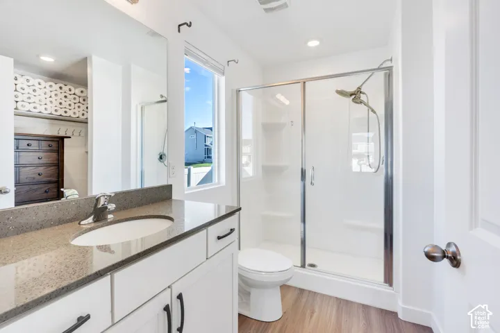 Master Bathroom. Vanity with a polished chrome faucet, stone countertop, and integrated sink