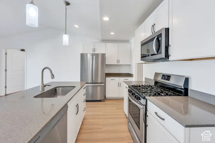 Modern kitchen featuring stainless steel Frigidaire and Whirlpool appliances, and a large apron sink.