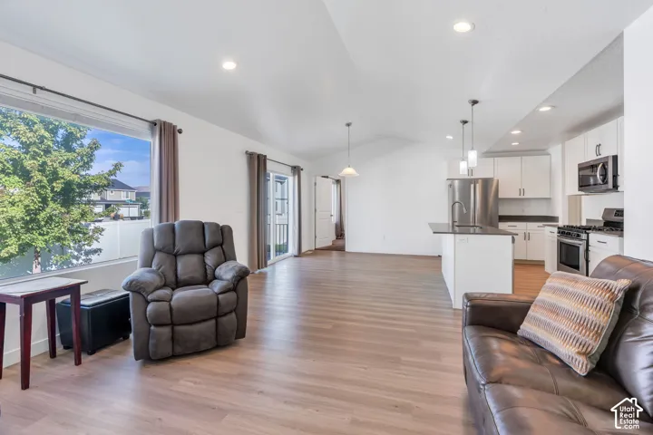 Open-concept living space with vaulted ceilings.