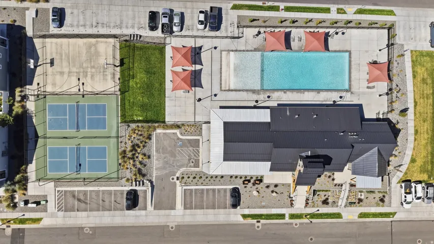 Community amenities featuring a swimming pool, two pickleball courts, a basketball half-court, and a manicured lawn area