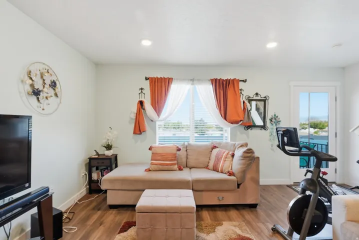 Recessed lighting, wood-finish flooring, and a glass-paned door