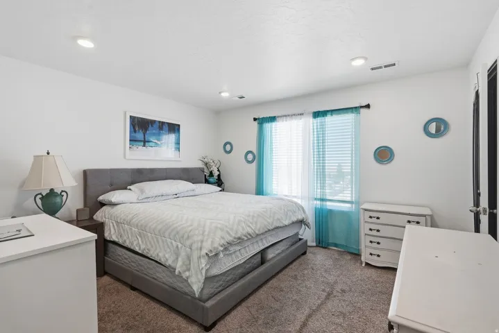 Recessed lighting, light-toned walls, and carpet flooring