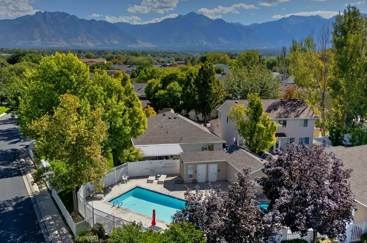 Outdoor swimming pool with surrounding fence and patio area