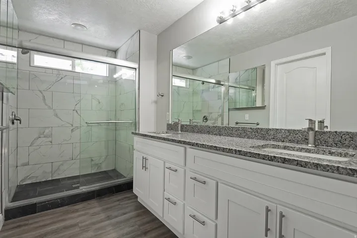 Walk-in shower with tile surround and glass enclosure