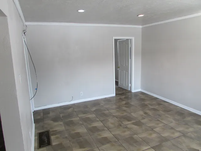 Recessed lighting, crown molding, and tiled flooring