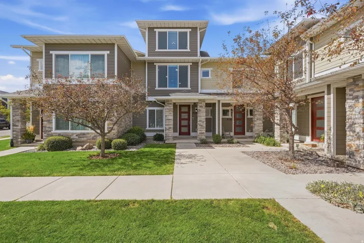 Modern multi-story exterior with stone veneer accents and siding