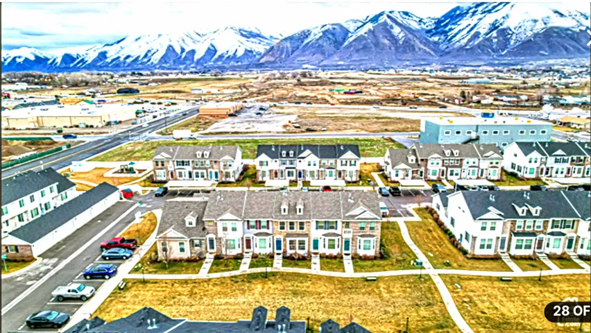 Aerial perspective of a residential community with snow-capped mountains in the background