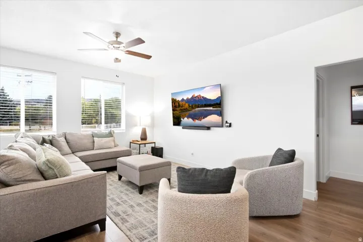 Recessed lighting, wood-finish flooring, and a ceiling fan with integrated lighting