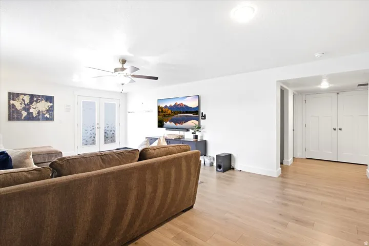 Recessed lighting, wood-finish flooring, ceiling fan, double French doors with frosted glass, and double paneled doors