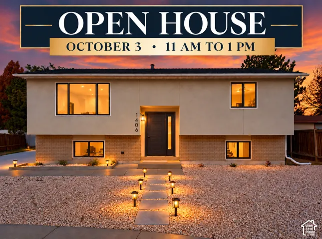 Stucco and brick exterior with contrasting trim, illuminated walkway with pathway lighting, and a dark-paneled entry door