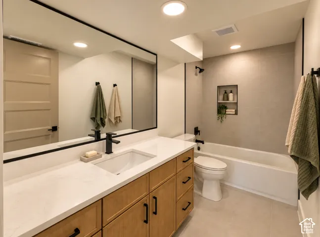 Light wood-finish vanity with a white countertop and integrated sink