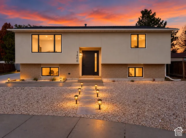 Smooth stucco and brick exterior with black-framed windows