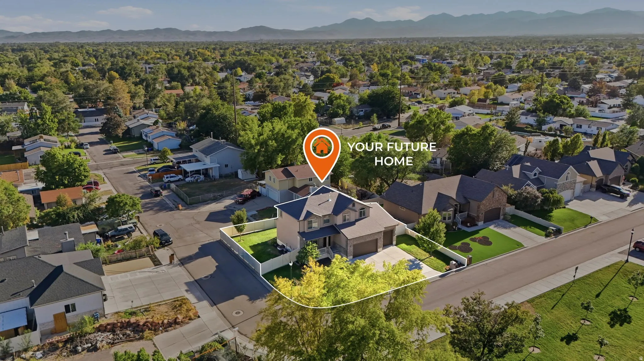 Aerial perspective highlighting a residential property with a multi-car garage, mature landscaping, and a fenced perimeter