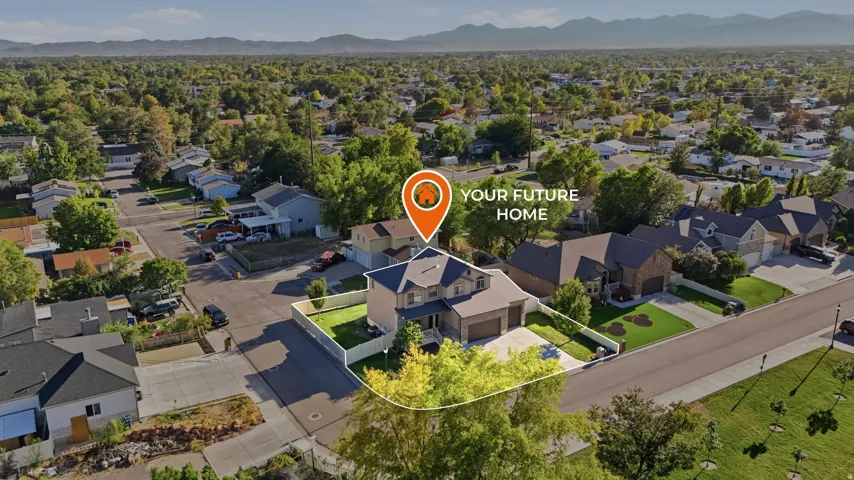 Aerial perspective highlighting a residential property with a multi-car garage, mature landscaping, and a fenced perimeter