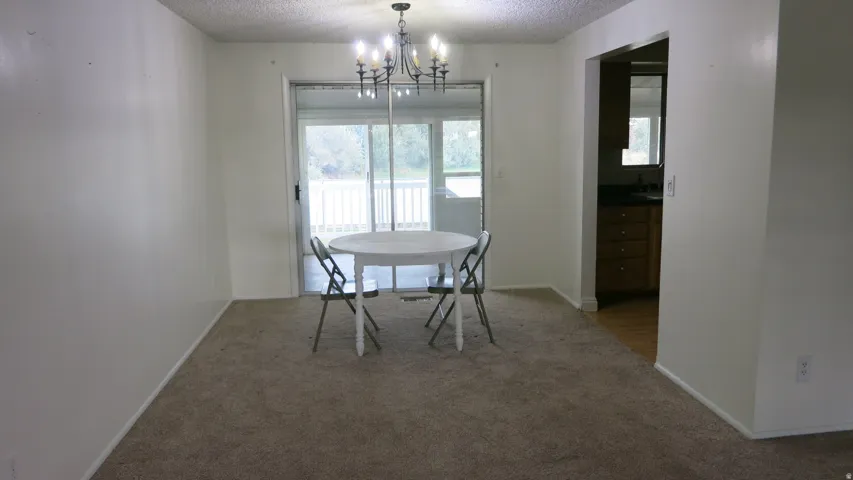 Carpeted living space with a chandelier light fixture
