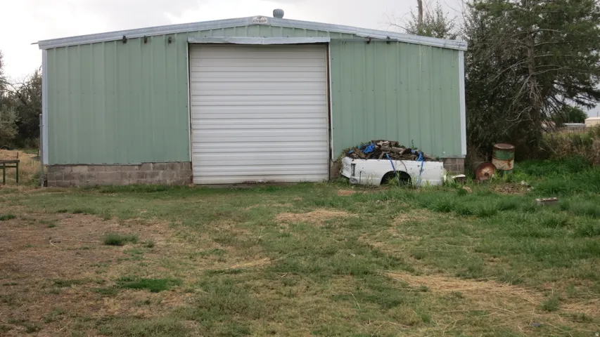 Metal-sided building with a concrete block foundation and a large roll-up door