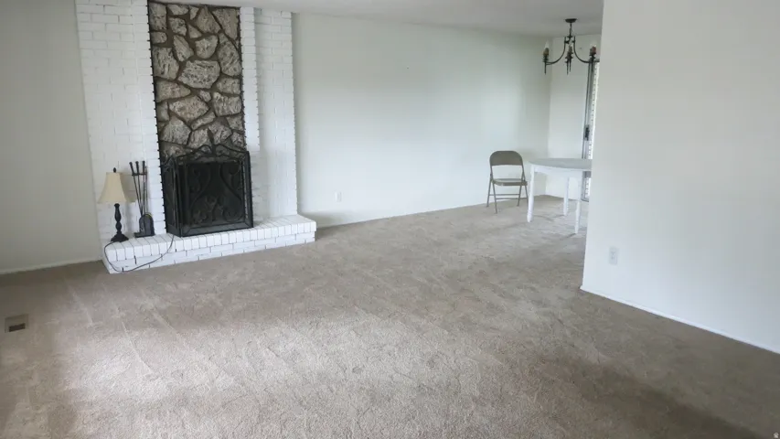 Central fireplace featuring a stone surround and painted brick hearth