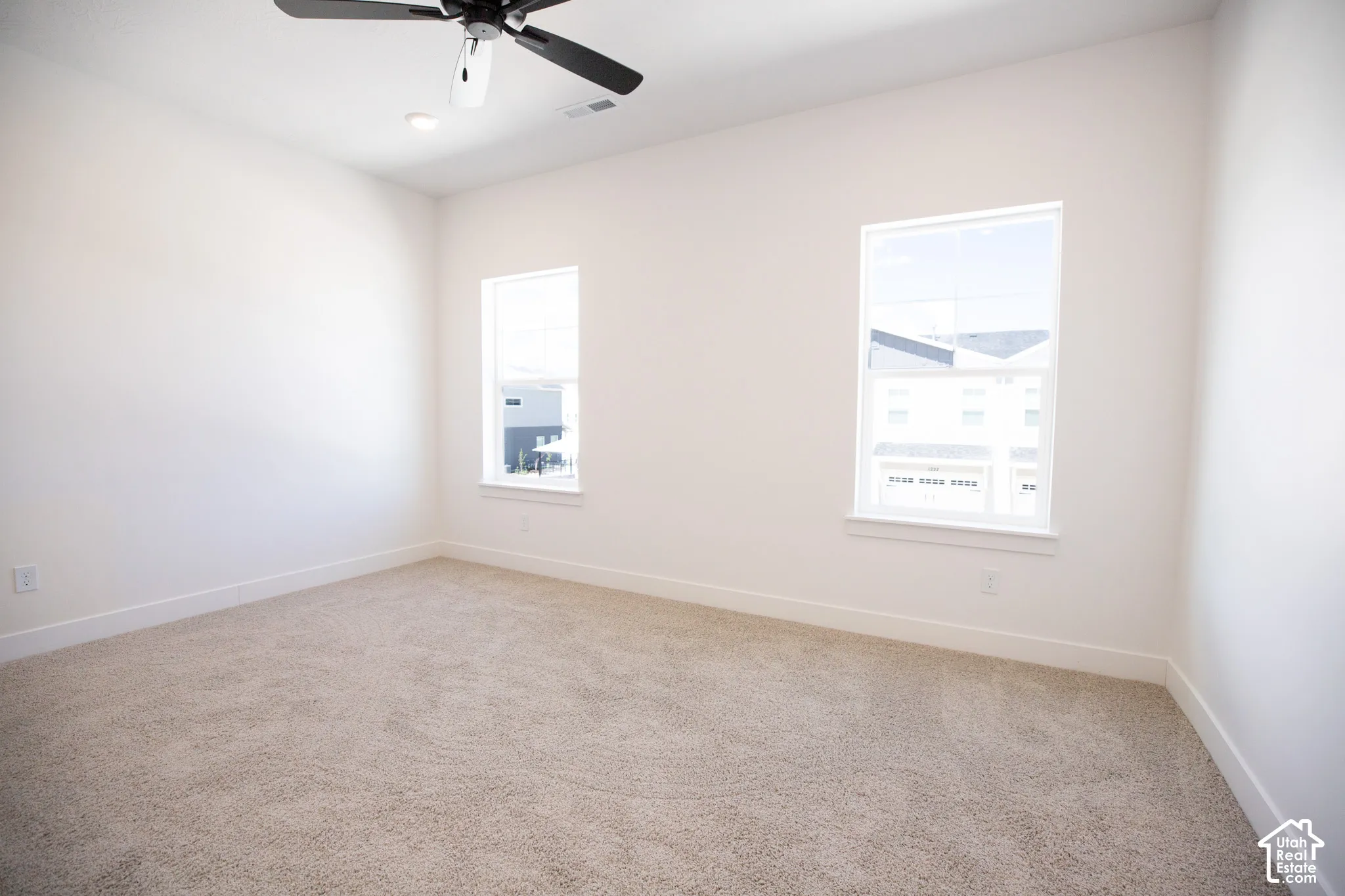 Primary bedroom with 9' ceiling and ceiling fan.