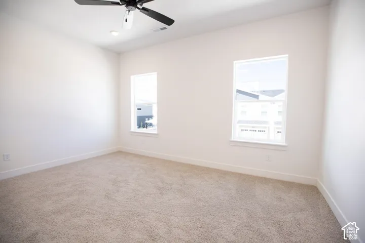 Primary bedroom with 9' ceiling and ceiling fan.