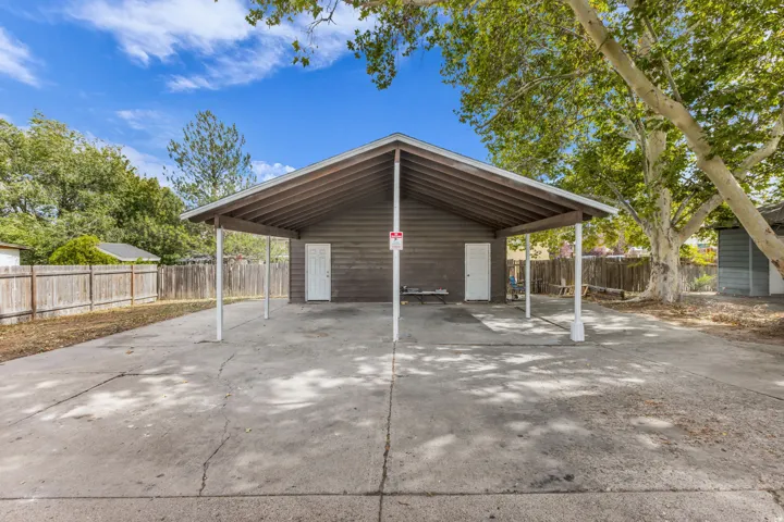 Covered carport structure with support pillars and a sloped roof