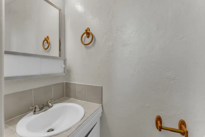 Oval undermount sink with a chrome-finish faucet, set into a tile countertop