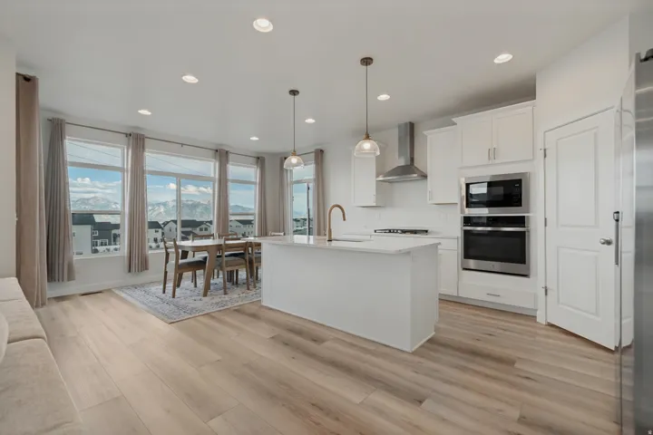 Modern kitchen with white cabinetry and stainless steel appliances