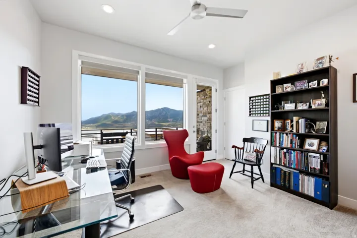 Spacious interior with large windows, recessed lighting, and a ceiling fan