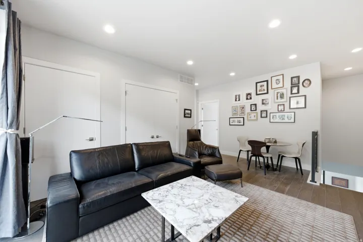 Recessed lighting, wood-finish flooring, and white interior doors