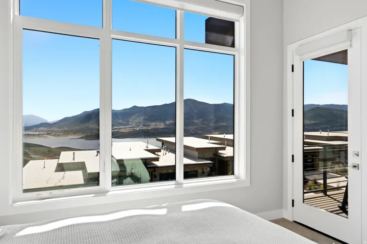 Expansive window wall with a mountain and lake backdrop