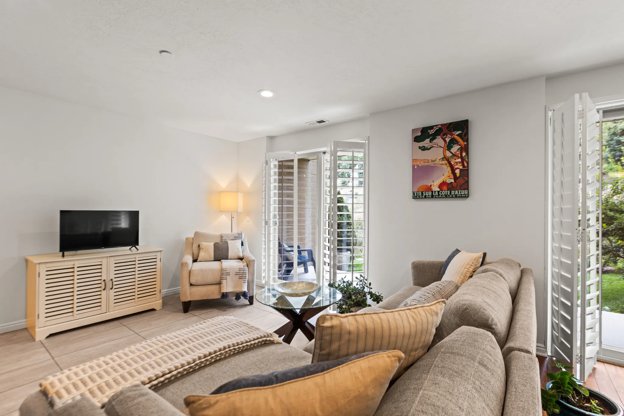 Recessed lighting, light-toned walls, and wood-finish flooring