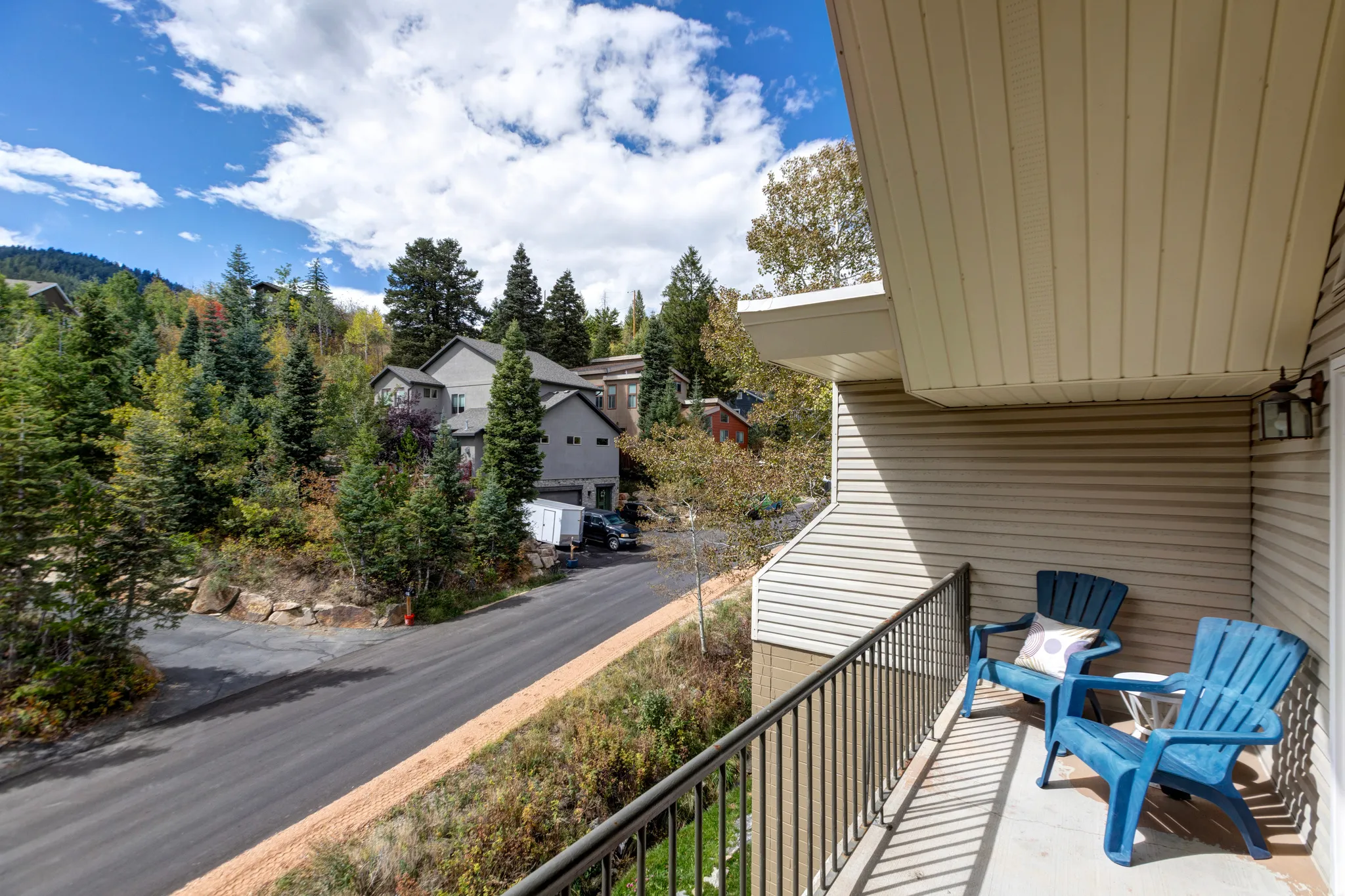Balcony with metal railing and exterior wall sconce