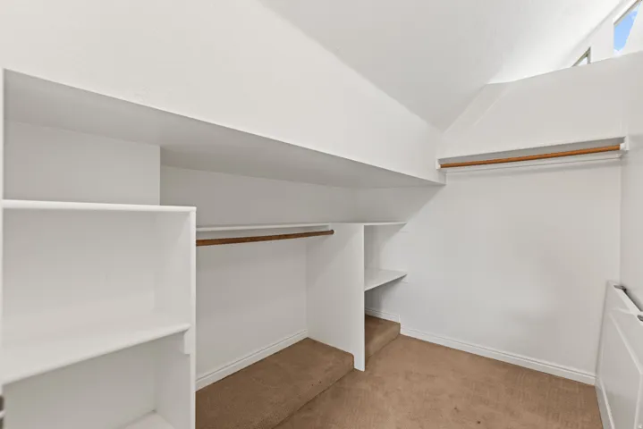 Integrated shelving units, multiple clothing rods, and sloped ceiling