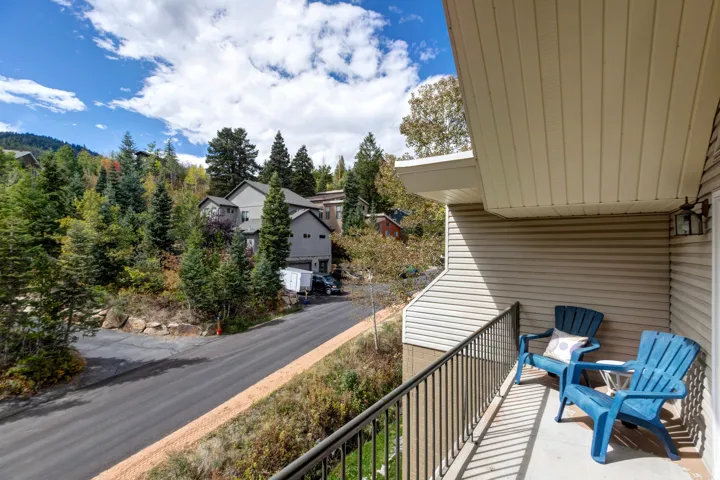 Balcony with metal railing and exterior wall sconce