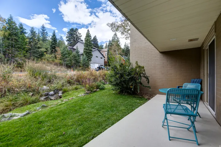 Covered patio with a concrete surface, a brick exterior wall, and a sliding glass door