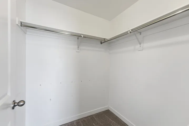 Built-in shelving with chrome hanging rods