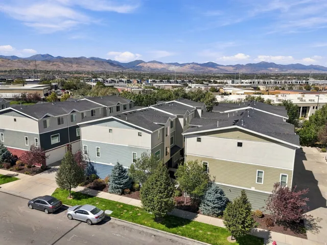 Townhome property featuring multi-level construction, distinct exterior siding, and a paved street
