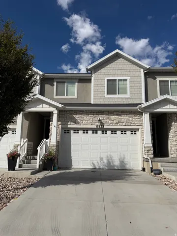 Stone and siding exterior with a two-car garage