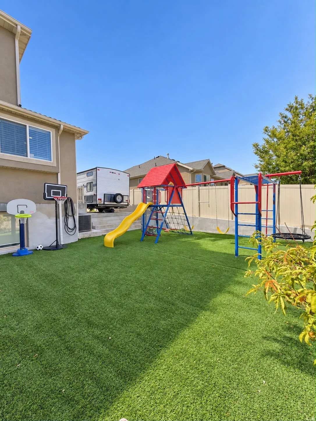 Rear yard featuring artificial turf and a privacy fence
