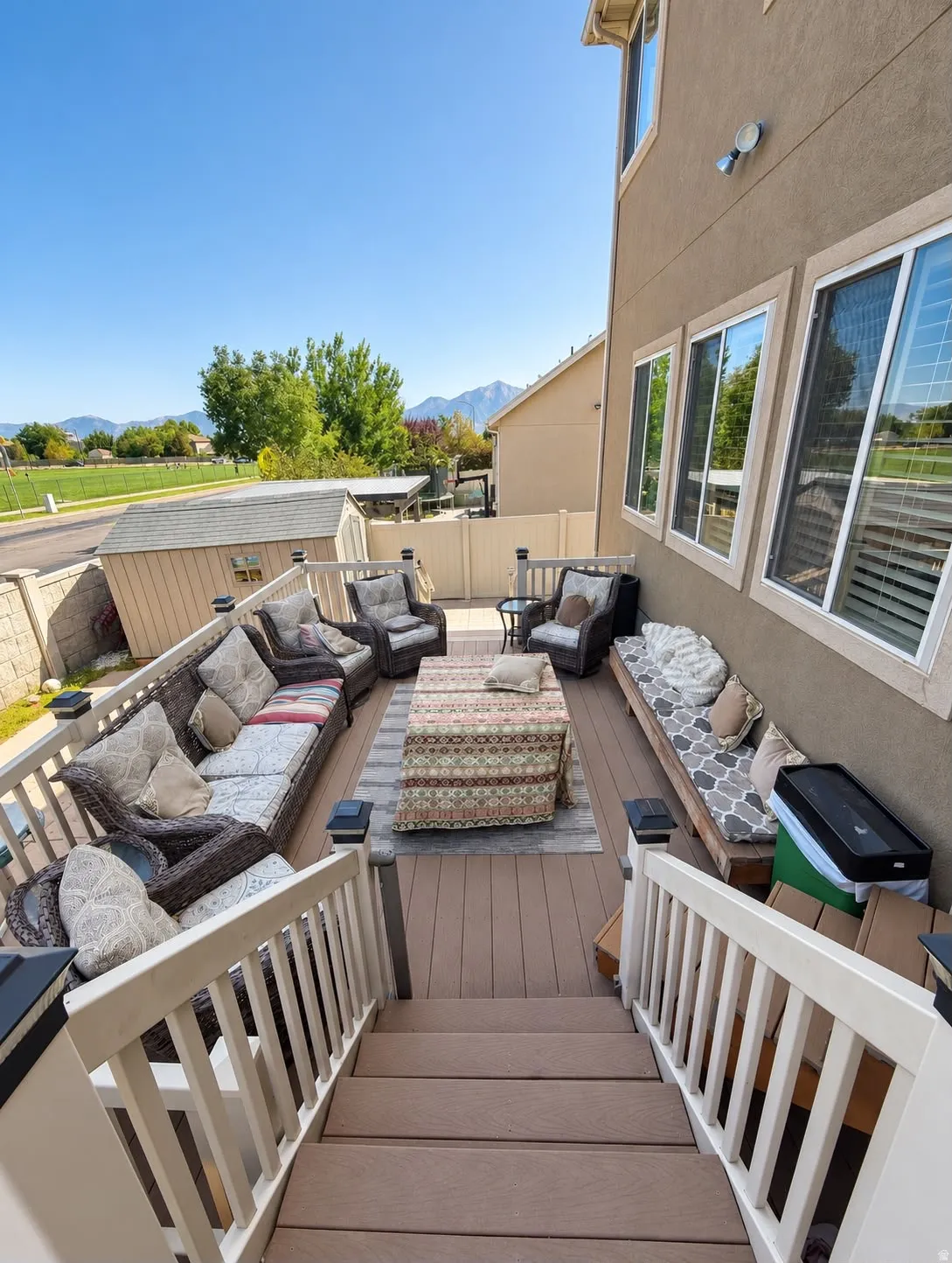 Multi-level composite deck with white railings and post cap lighting