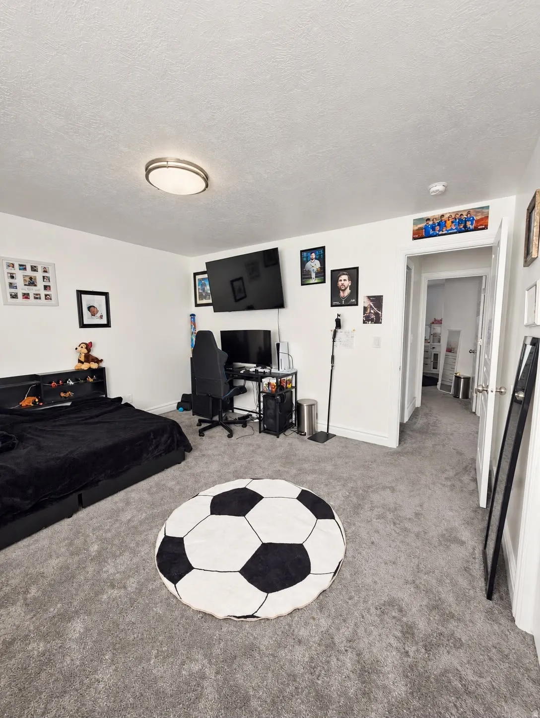 Recessed ceiling lighting, light gray wall paint, and gray carpeting